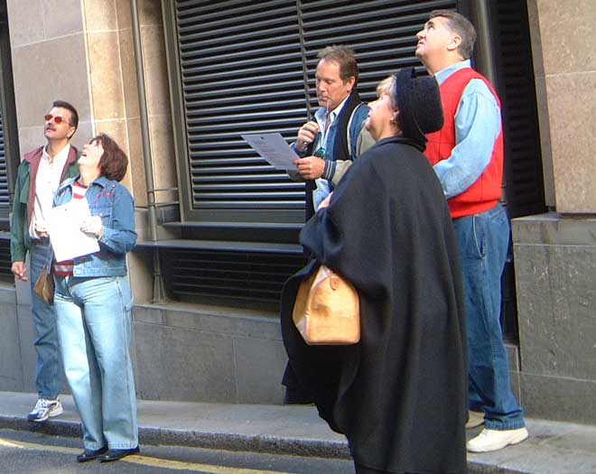 People looking up for a treasure hunt clue in London.