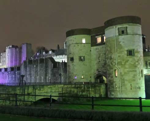 Two of the Tower of London's towers shown by night.
