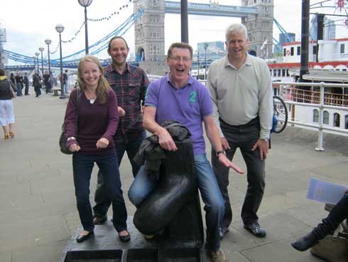 People by Tower Bridge on a London sightseeing tour.