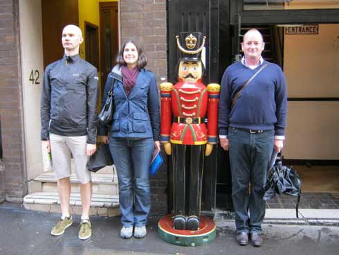 People on a London sightseeing car tour imitating a toy soldier.